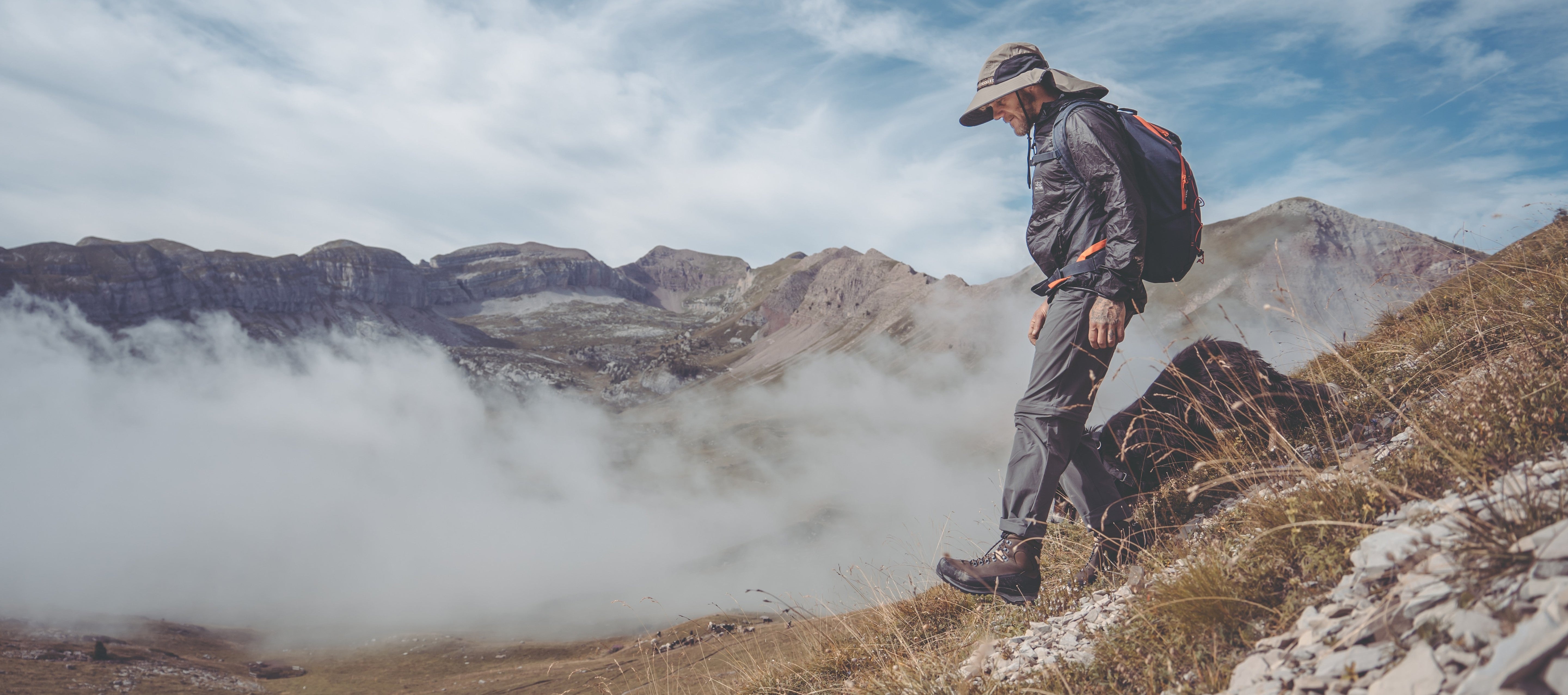 Person wearing a wide-brim sun hat while hiking in snow, New Zealand winter